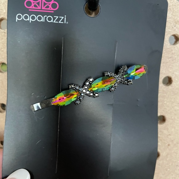 Oil spill hair clip with two rhinestone X’s.